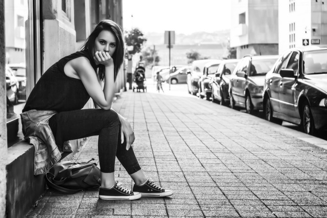 young woman sitting on stoop