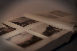 A picture of a photo album with sentimental photographs in it. 