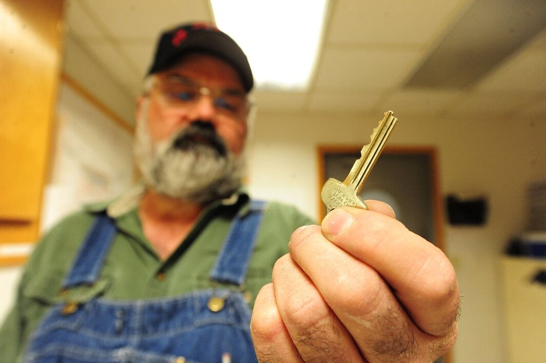 a locksmith holding a key