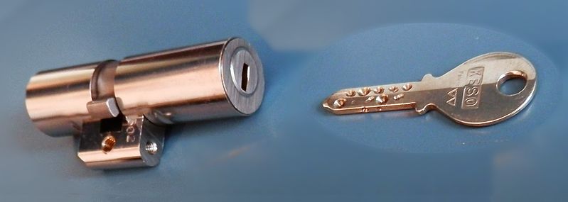 A key next to a lock cylinder.