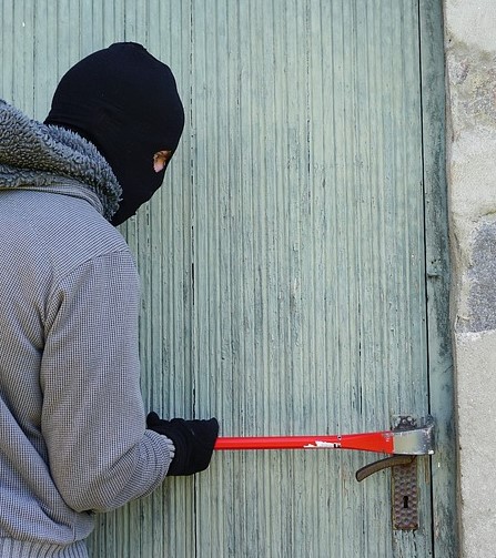 thief breaking door lock