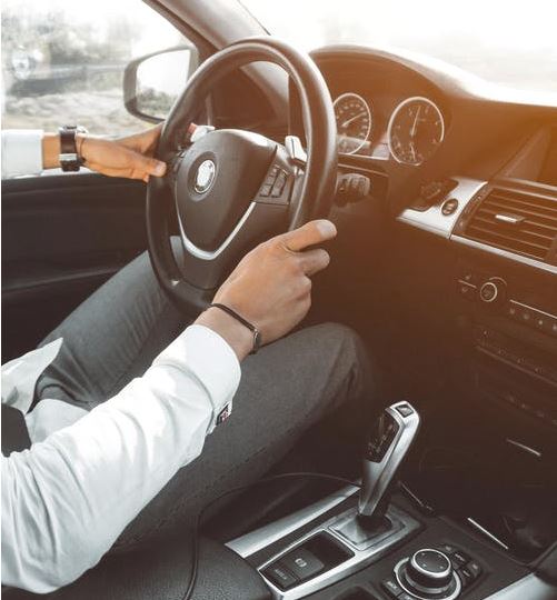 man driving in a new car